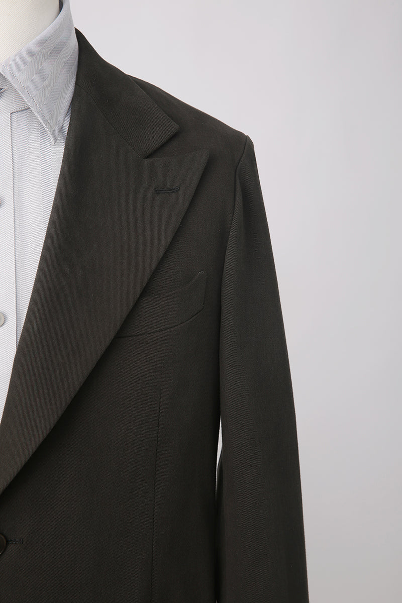 Custom lapel and buttons on tailored dark green men’s blazer
