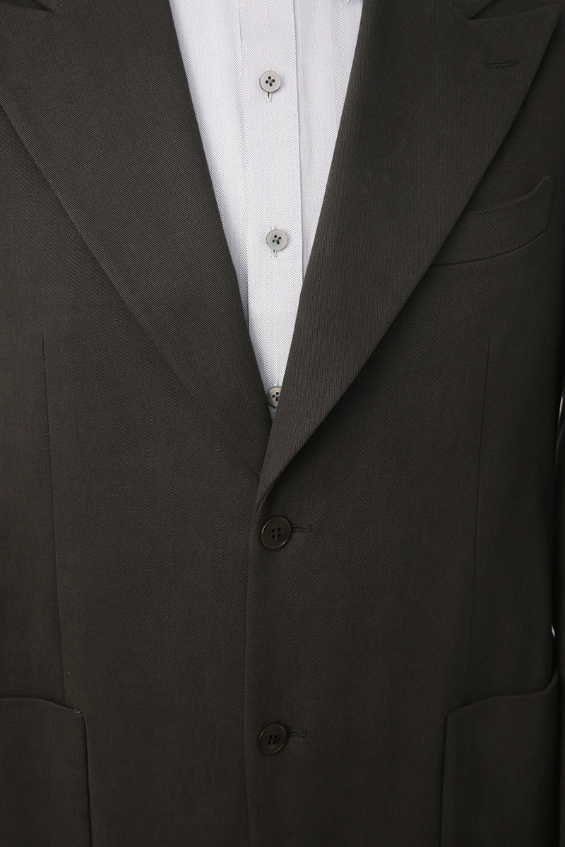 Luxury fabric texture on bespoke dark green suit jacket
