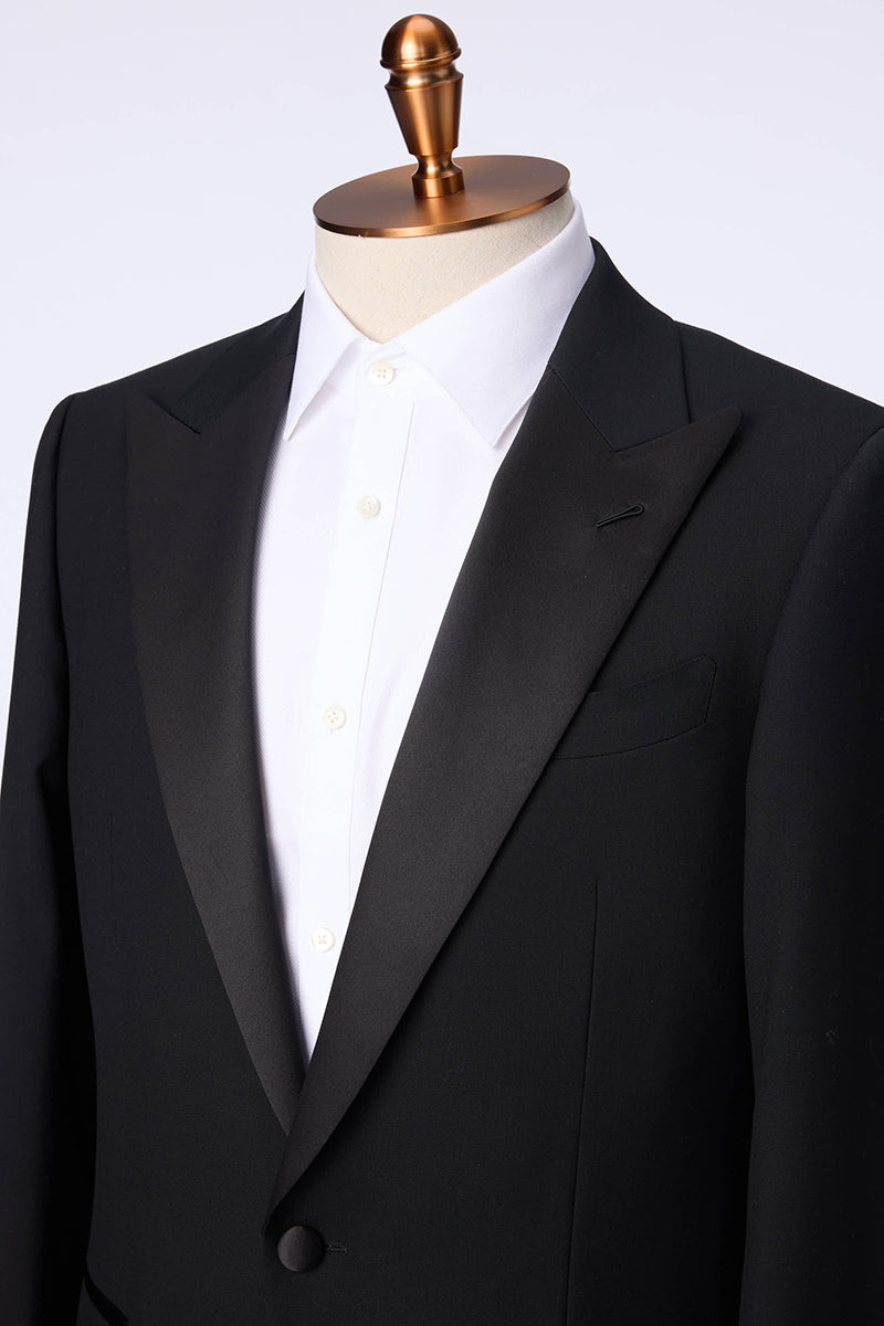 Custom peak lapel and buttons on tailored black tuxedo