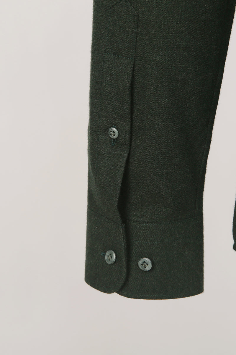 Custom sleeve buttons on tailored dark green shirt