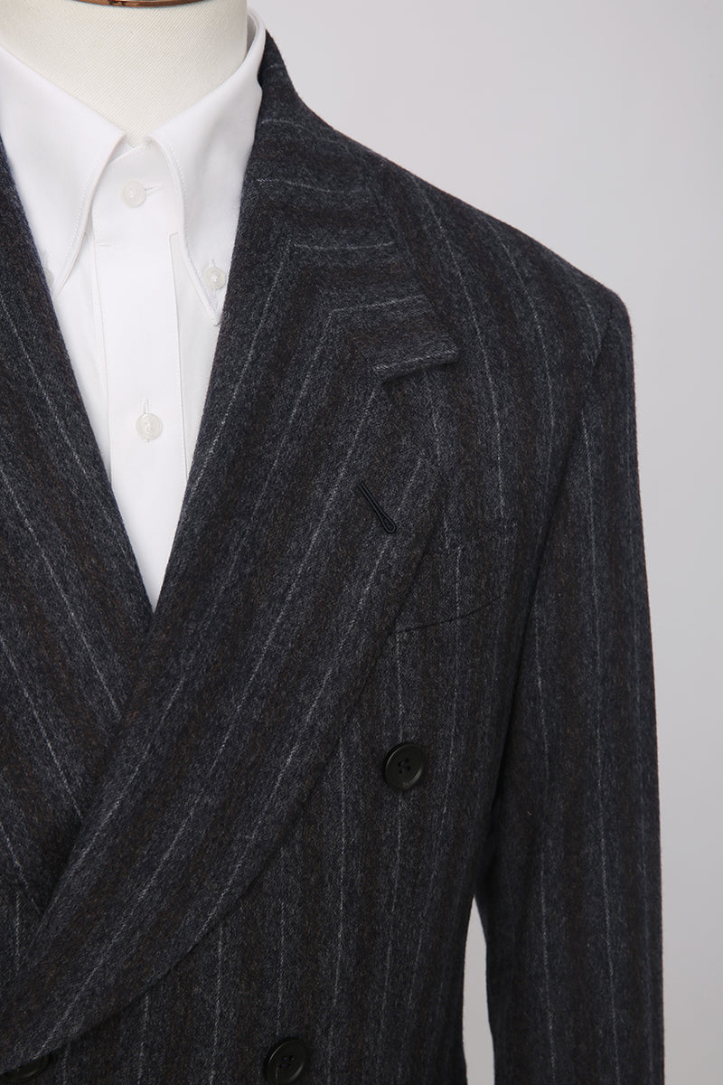 Custom lapel and buttons on tailored charcoal pinstripe blazer