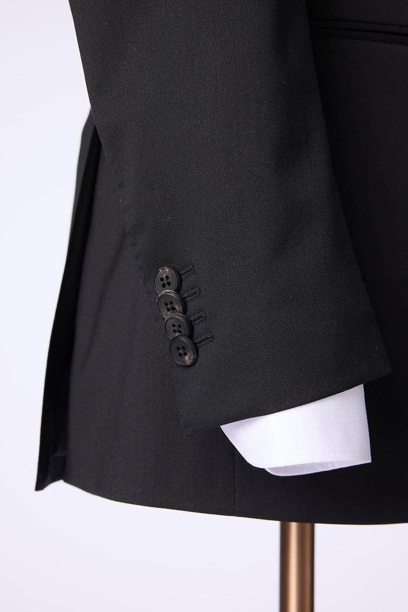 Custom sleeve buttons on tailored double-breasted black suit