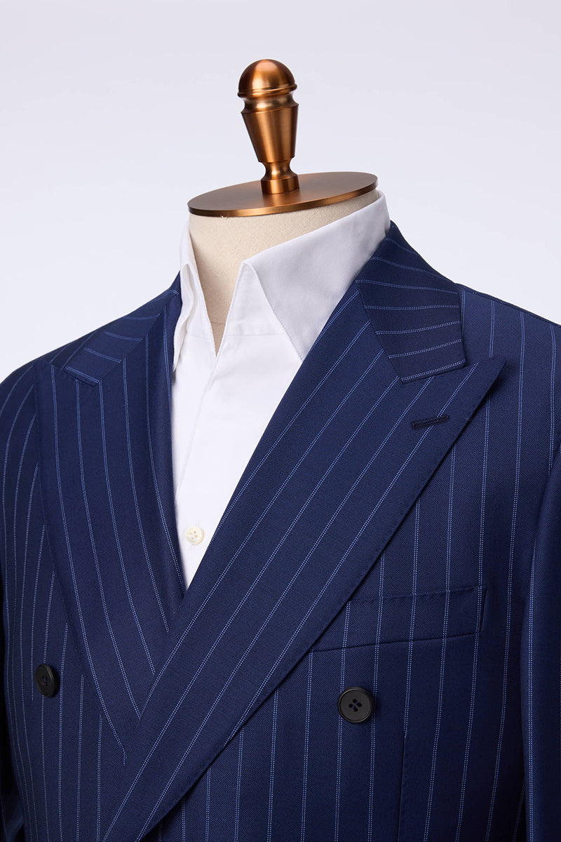 Custom lapel and buttons on tailored double-breasted navy pinstripe suit