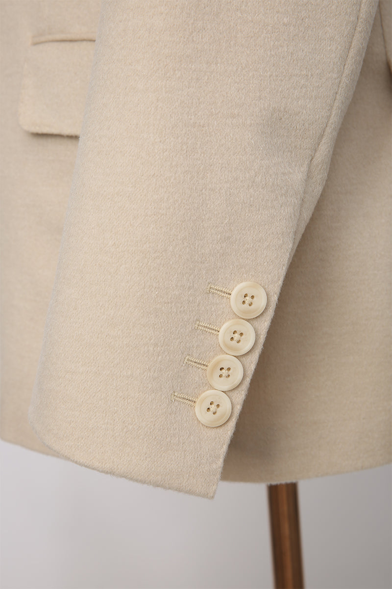 Custom sleeve buttons on tailored light khaki camel hair and silk suit