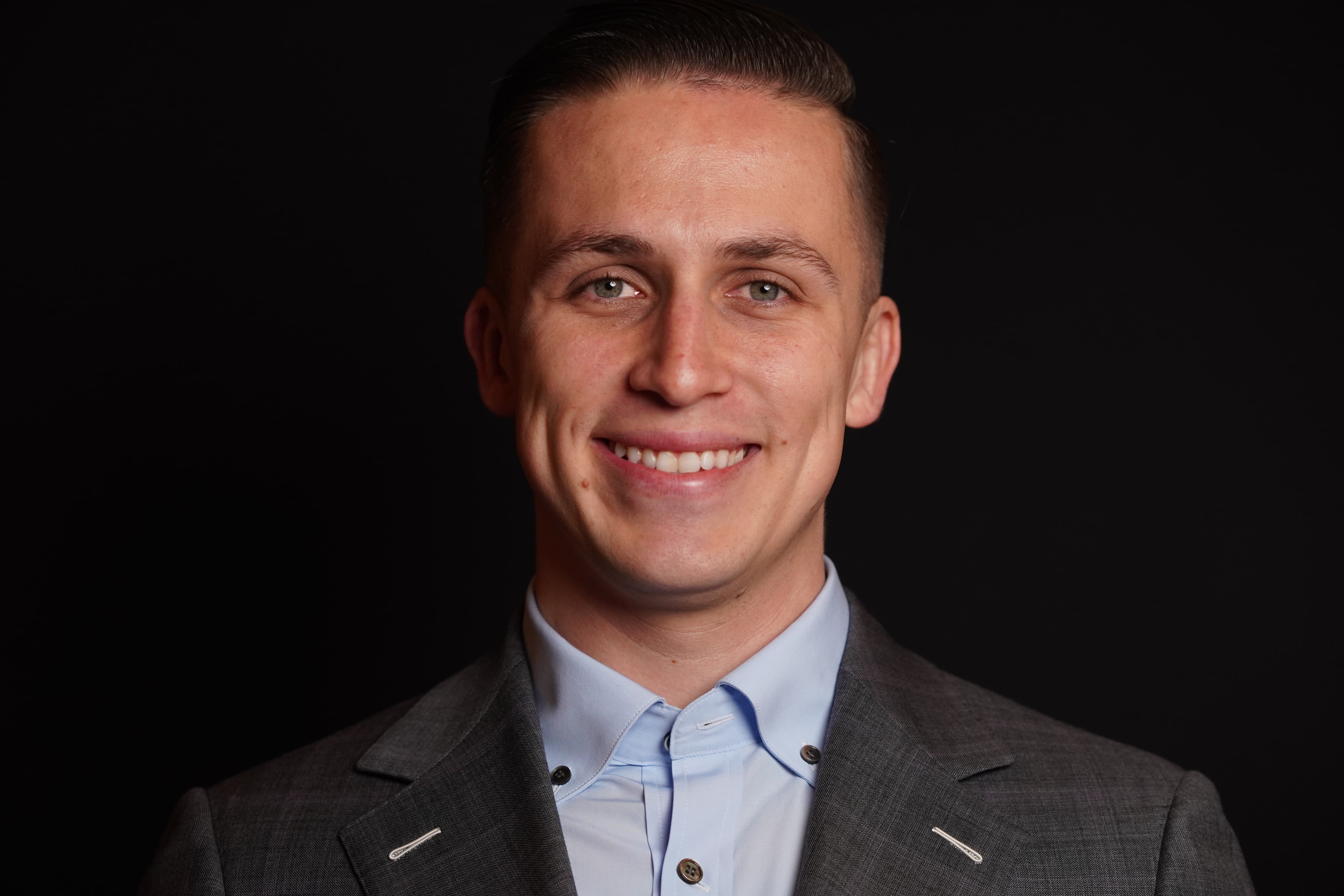 Sam Cole, founder of Crowned Legacy Suits and Tuxedos, photographed in studio.