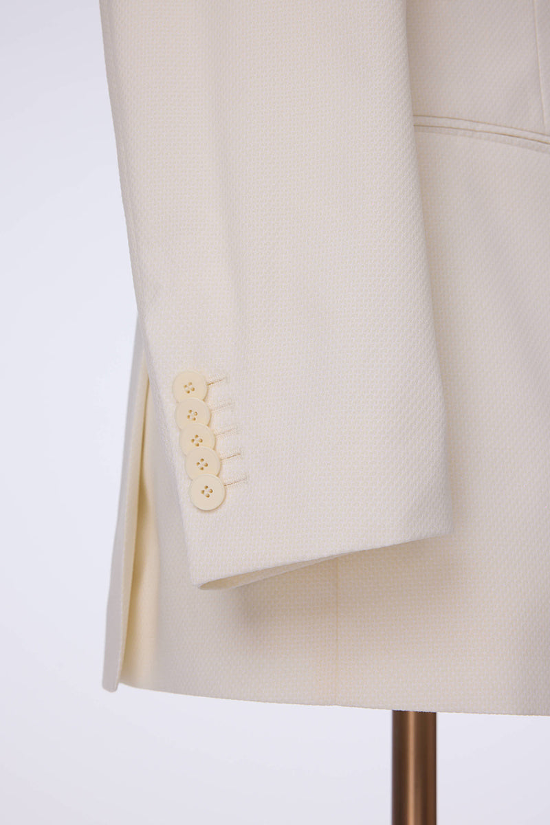Custom sleeve buttons on tailored ivory tuxedo