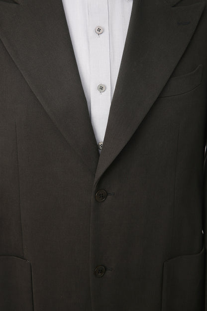 Luxury fabric texture on bespoke dark green suit jacket