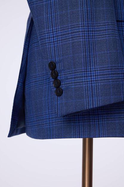 Custom sleeve buttons on tailored blue plaid suit