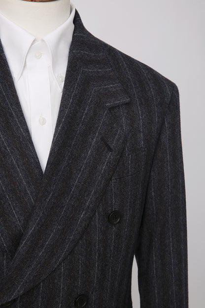 Custom lapel and buttons on tailored charcoal pinstripe blazer