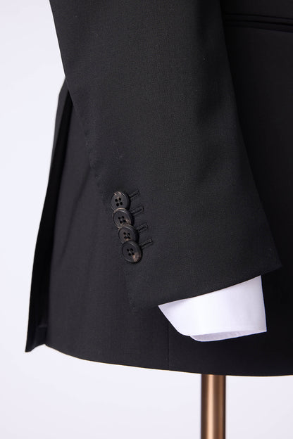 Custom sleeve buttons on tailored double-breasted black suit