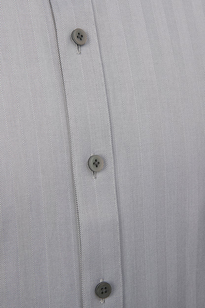 Luxury herringbone fabric texture on bespoke grey dress shir