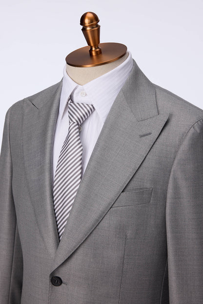 Custom lapel and buttons on tailored light grey silk blend suit