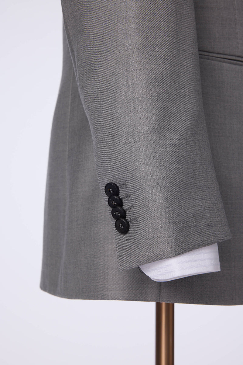 Custom sleeve buttons on tailored light grey silk blend suit
