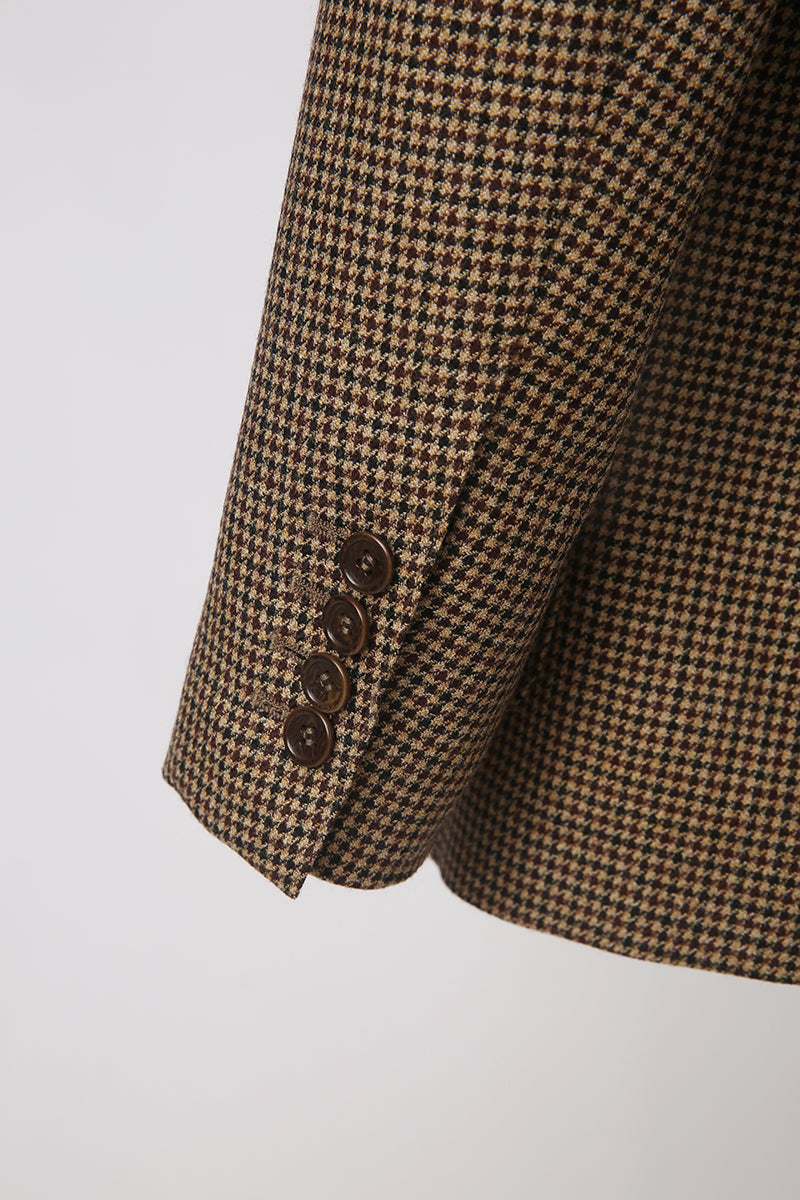 Custom sleeve buttons on tailored houndstooth men’s jacket 