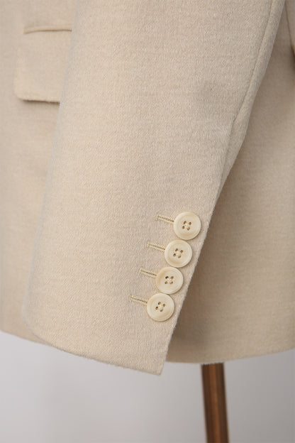 Custom sleeve buttons on tailored light khaki camel hair and silk suit