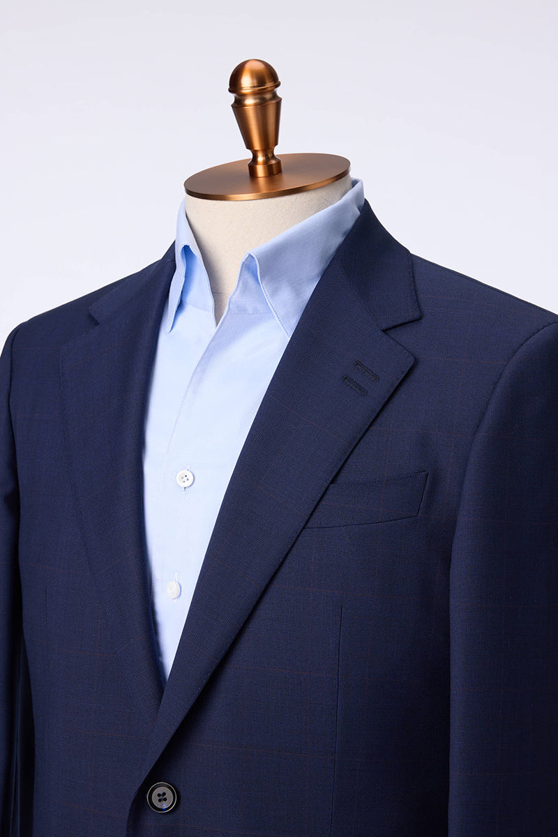Custom lapel and button detail on navy plaid bespoke suit
